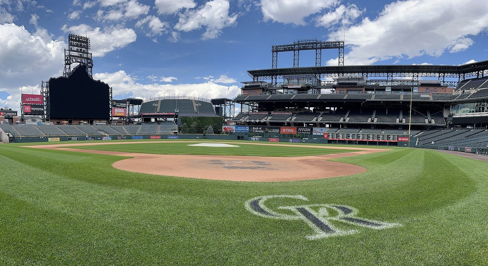 Coors Field in Denver from the infield grass behind home plate, where the Padres face Tanner Gordon and the Rockies